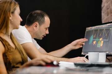 Youn man showing his colleague something on the screen