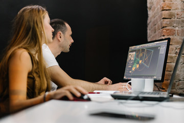 Two young professionals working at night