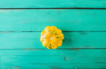 Yellow squash on a wooden turquoise background. Top view,  Colorful festive still life. Copyspace. 