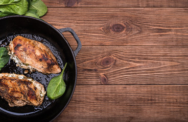 Spinach and feta stuffed chicken breast  in a frying pan.