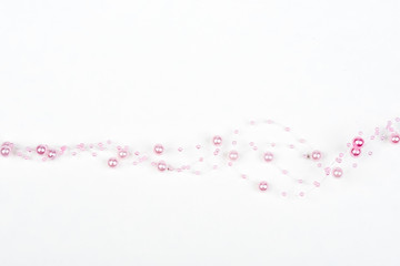 Christmas, wedding, vanetine, greeting decoration – big and small pink pearls on the line (string). Pearl decoration isolated on white background. Pink balls.