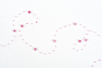 Christmas, wedding, vanetine, greeting decoration – big and small pink pearls on the line (string). Pearl decoration isolated on white background. Pink balls.