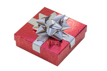 Gift box wrapped in red patterned paper with shiny silver ribbon