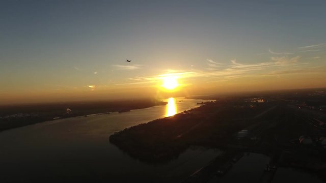 Aerial View of Plane Flying over Delaware River into Sunset