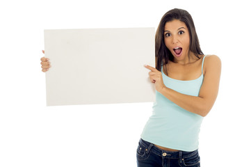 young attractive and happy hispanic woman holding blank billboard with copy space