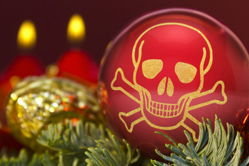 Red bauble with the golden shape of a skull. (series)