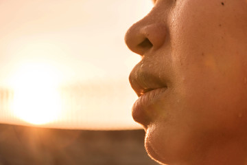 Close-up sweating on face of asian women,exercise on sunset background