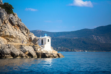 Fototapeta na wymiar Tower lighthouse on the cliffs in the Aegean sea, Greece.