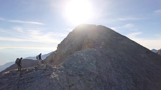 Drone Footage Of Male Hikers Walking On Rocky Mountain Against Sky Adventure Extreme Sport Landscape Nature Beautiful Aerial Travel Danger Active Exploration