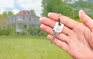 Hand with house key.