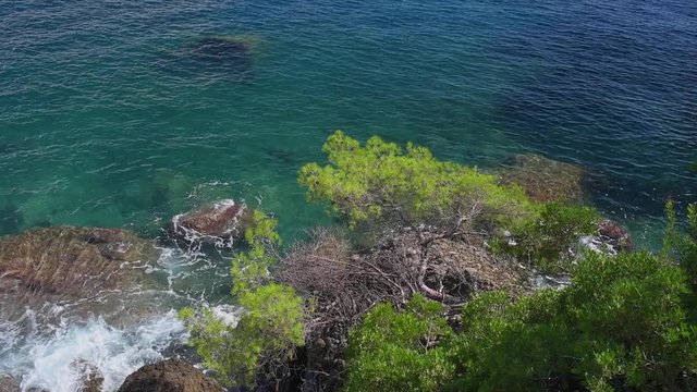 Crystal clear waters of the Ligurian sea breaking on the Portofino national park coastline.