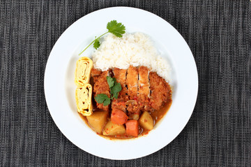 Rice with fried pork,omelet roll topped Japanese yellow curry .
