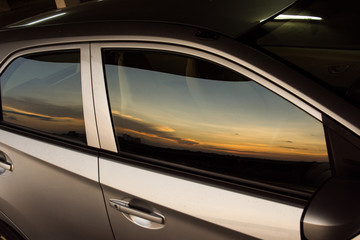 Obraz na płótnie Canvas Sunset over vehicles