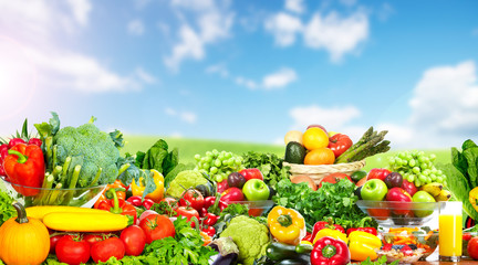 Vegetables and fruits over blue sky background.