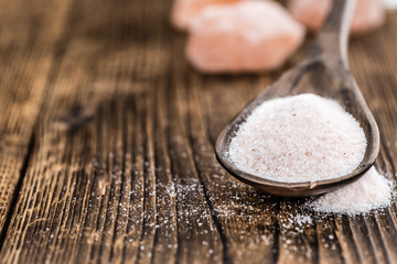 Himalayan Salt on wooden background (selective focus)