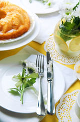 Yellow summer table setting with lemon bundt cake