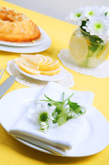 Yellow summer table setting with lemon bundt cake