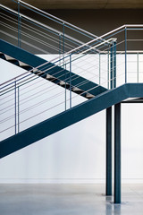 Blue metal staircase. Interior warehouse stairs. Emergency exit stairs.