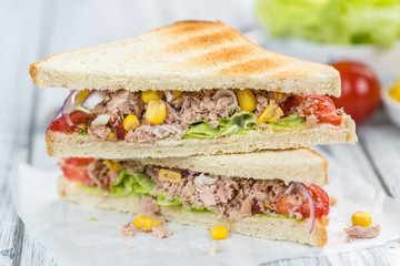 Wooden table with a Tuna Sandwich (selective focus)