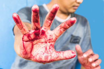 Bloody theme lone murderer: the murderer shows bloody hands and