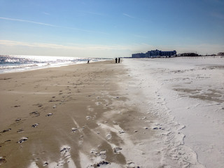 Snow lying on a sandy beach in winter