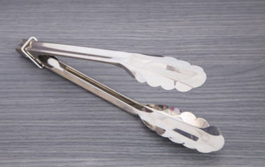 Serving kitchen tongs isolated on a white background
