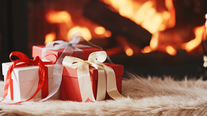 Festive Gift Box standing by the Burning Fireplace - Close Up. D