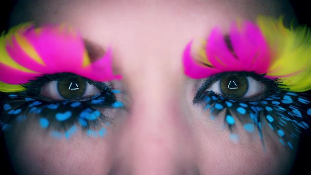 4k Colourful Woman Eyes Close-up with Feathers Eyelashes Flapping