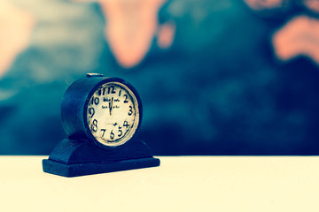 Clock against grunge world map