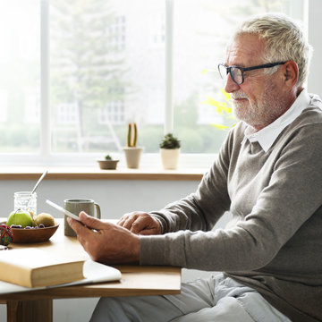 Senior Adult using Digital Device Tablet Concept