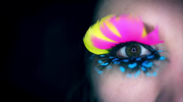 4k Colourful Woman Eyes Close-up with Feathers Eyelashes Flapping