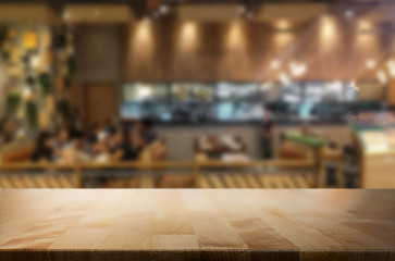 Selected focus empty brown wooden table and Coffee shop blur bac