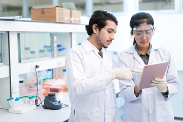 Scientists asian in the laboratory they use a tablet recording t