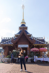 Thai woman with pomeranian at wat Ban Den In Chiangmai Thailand