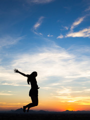 Fototapeta na wymiar Young woman enjoying outdoors, sky background,sunset
