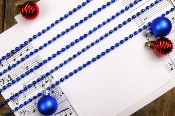 Christmas tree decorations on the table and sheet with music not