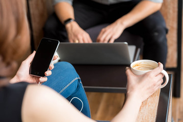 Group of friends meeting in a coffee shop chatting to each other