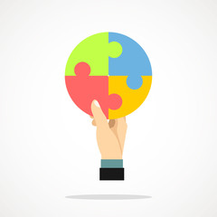 The hand holds puzzle pieces. Vector image.