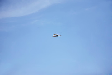 light aircraft flying in the blue sky
