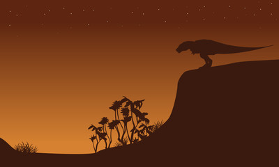Silhouette of Tyrannosaurus on cliff