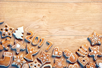 Christmas background with Gingerbread cookies on wooden table. Copy space for your text. Top view