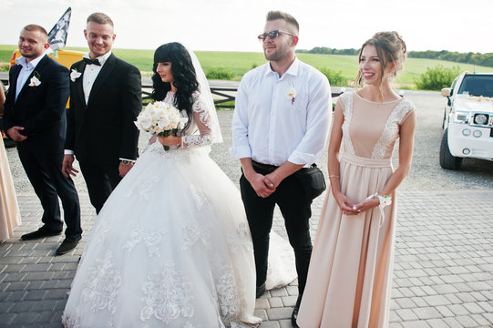 Wedding couple and bridesmaids with best mans background wedding