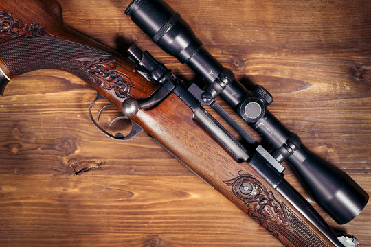 Sniper on wooden background