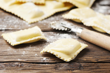 Uncooked ravioli on the wooden table