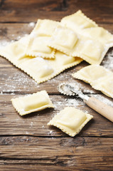 Uncooked ravioli on the wooden table