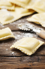 Uncooked ravioli on the wooden table