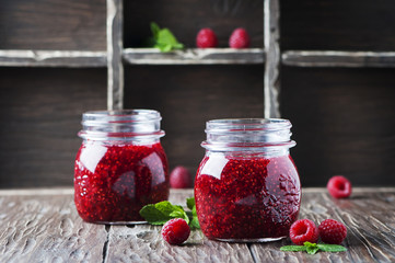 Homemade jam with raspberry on the wooden table