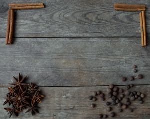 anise pepper and cinnamon sticks on wooden background