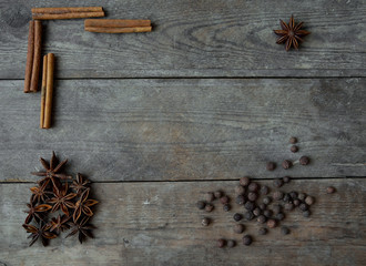 anise pepper and cinnamon sticks on wooden background