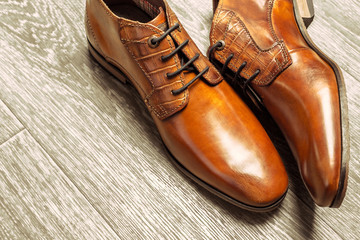 Fashion concept with male shoes on wooden background